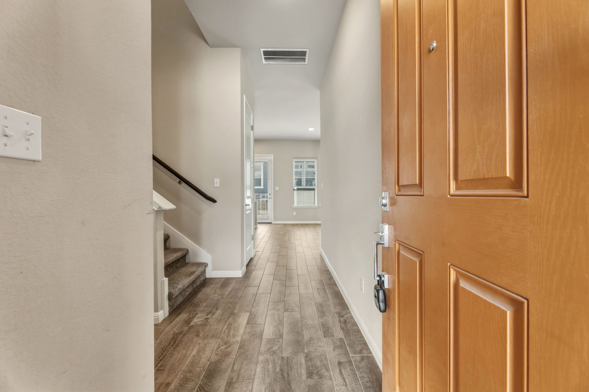 1015 Vista View Drive, Unit 2102 Georgetown, TX 78626 - Photo 6 of 40 a view of a hallway with wooden floor and staircase