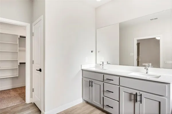 a bathroom with a double vanity sink and a mirror