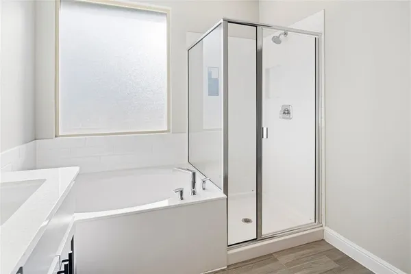a bathroom with a bathtub and a shower