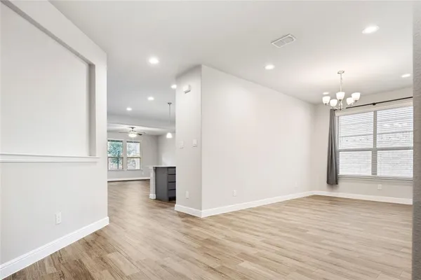 a view of a room with wooden floor and windows