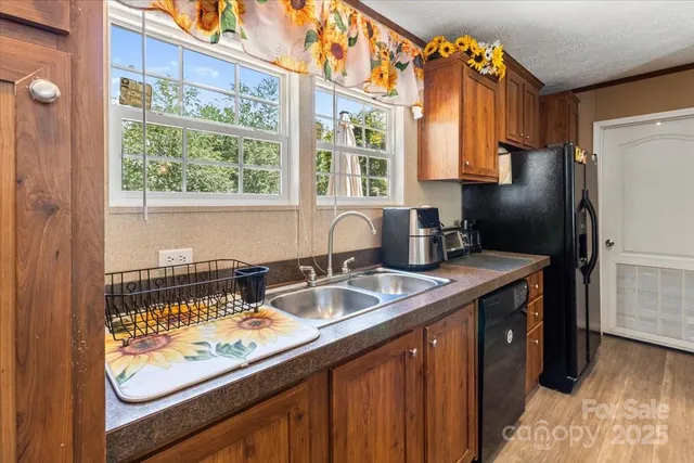 a kitchen with a stove a refrigerator and a sink