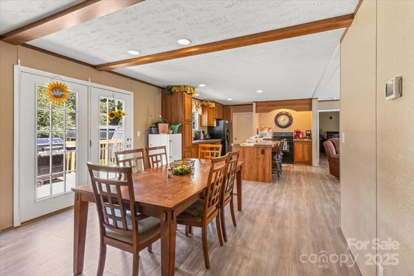a dining room with furniture and wooden floor