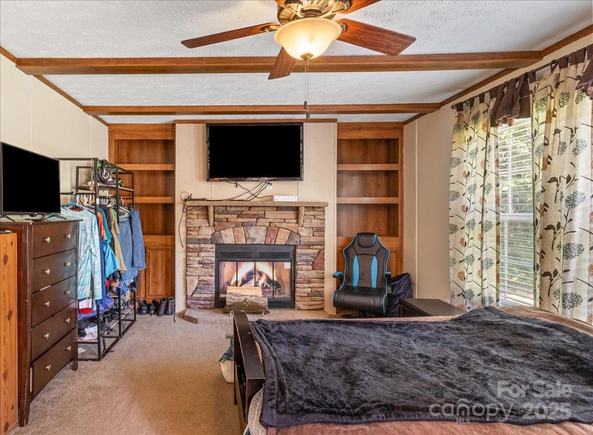 132 Bailey Mountain Road Mars Hill, NC 28754 - Photo 23 of 33 a living room with fireplace furniture and a flat screen tv