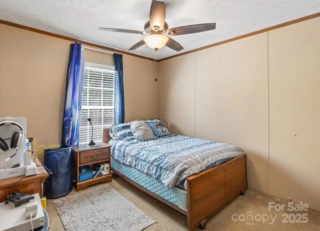 a bedroom with a bed a table and chair