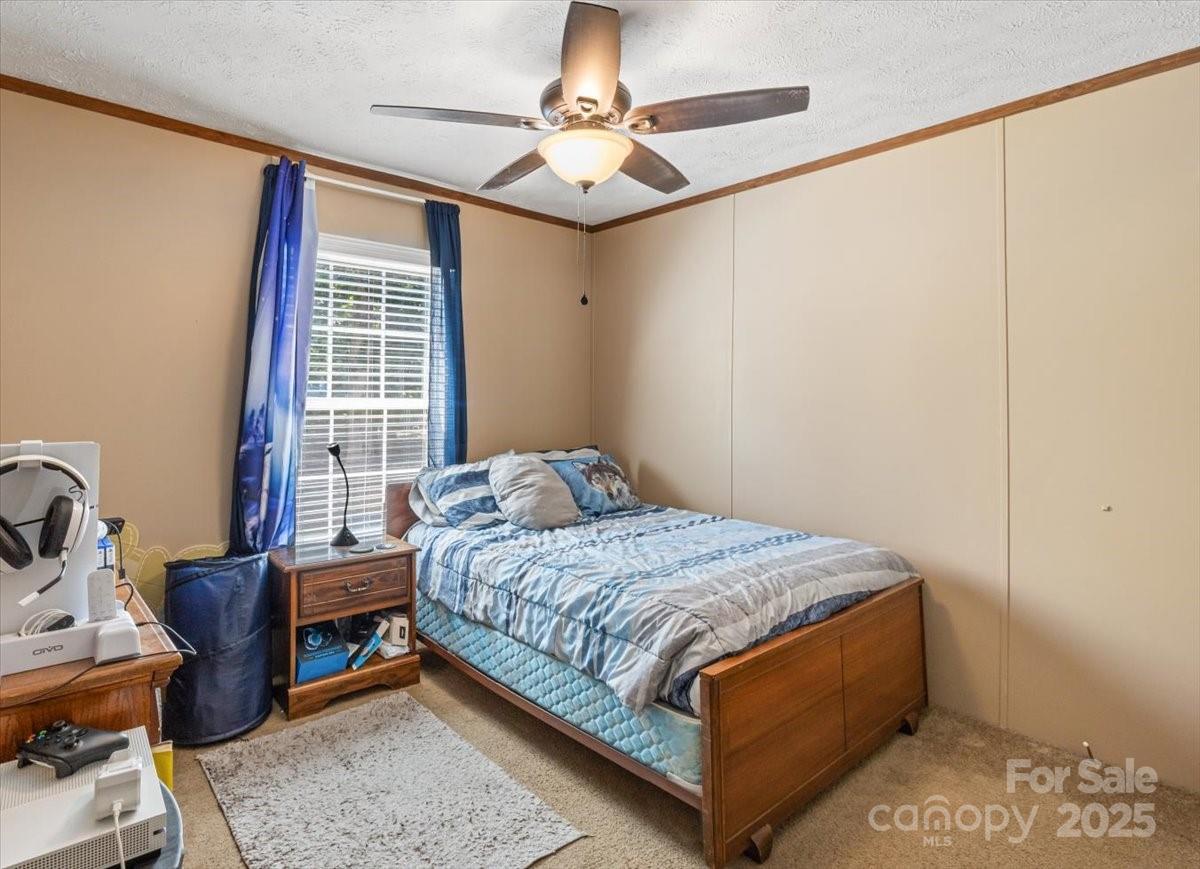 132 Bailey Mountain Road Mars Hill, NC 28754 - Photo 24 of 33 a bedroom with a bed a table and chair