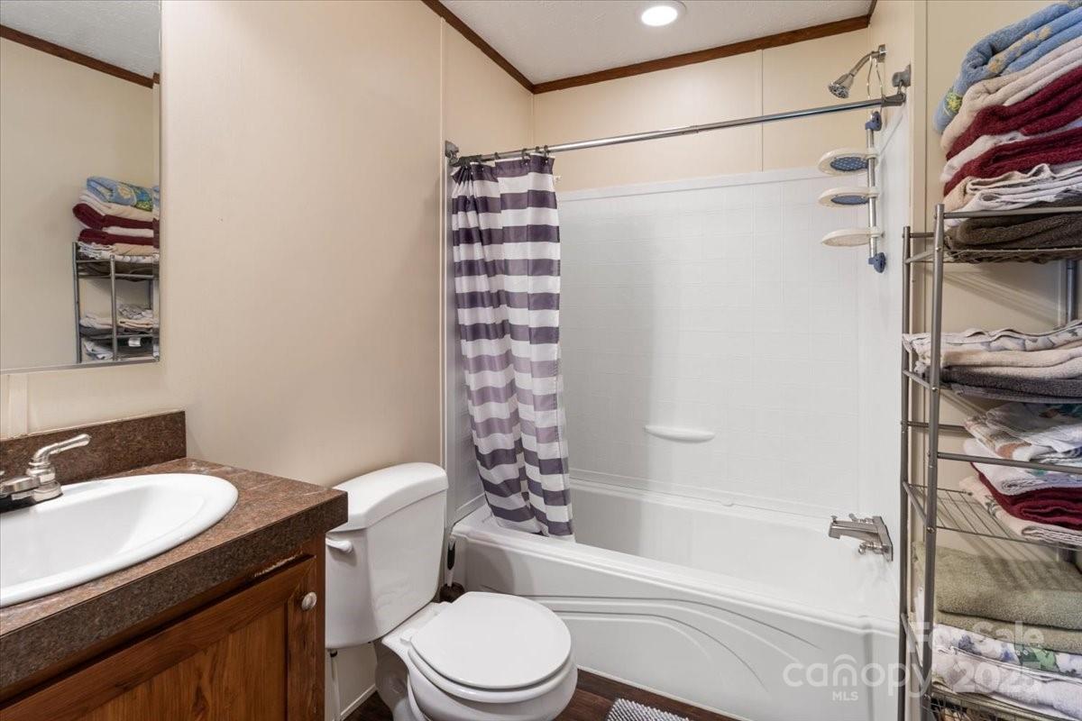 132 Bailey Mountain Road Mars Hill, NC 28754 - Photo 25 of 33 a bathroom with a sink toilet and shower