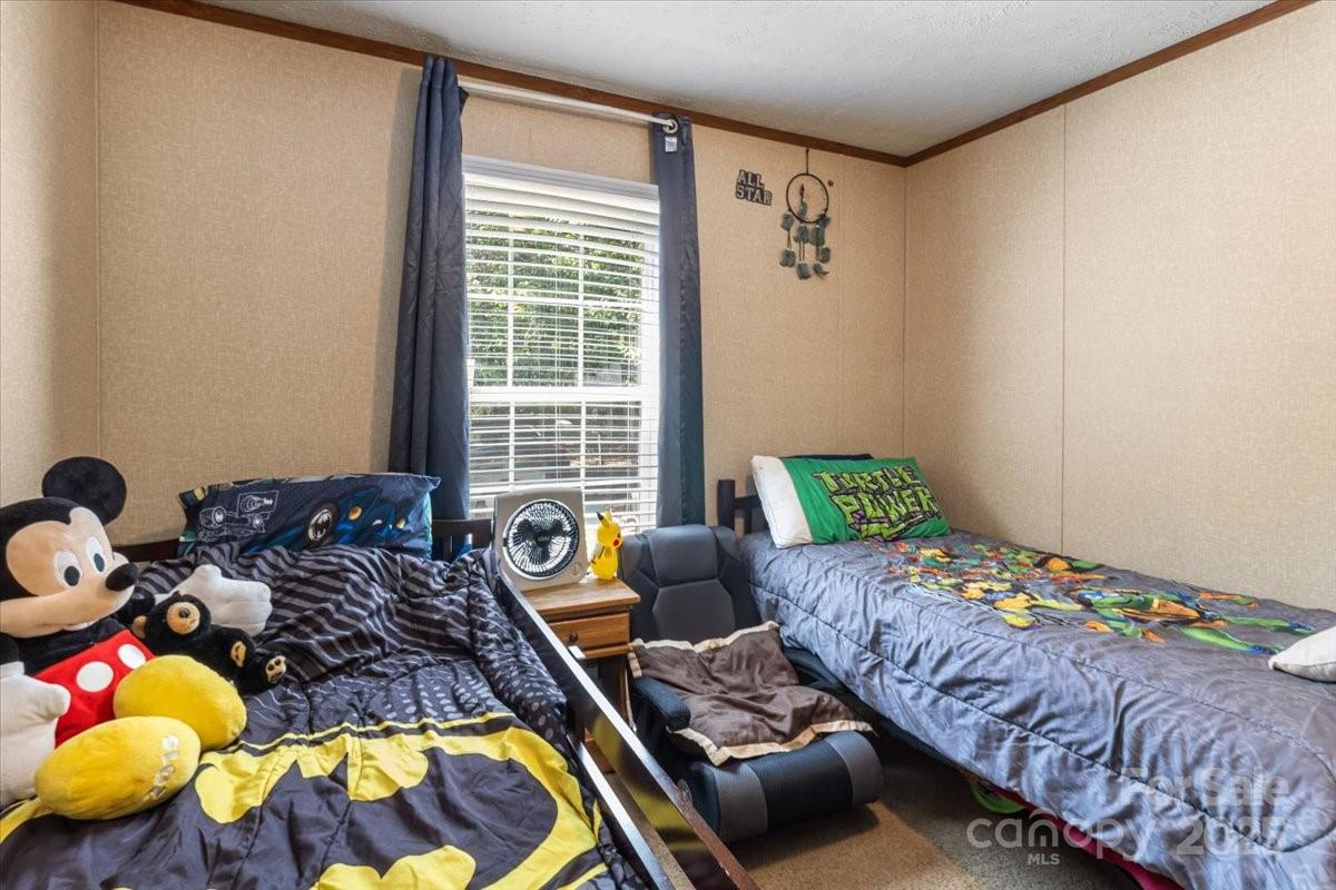 132 Bailey Mountain Road Mars Hill, NC 28754 - Photo 26 of 33 a bedroom with bed and a window