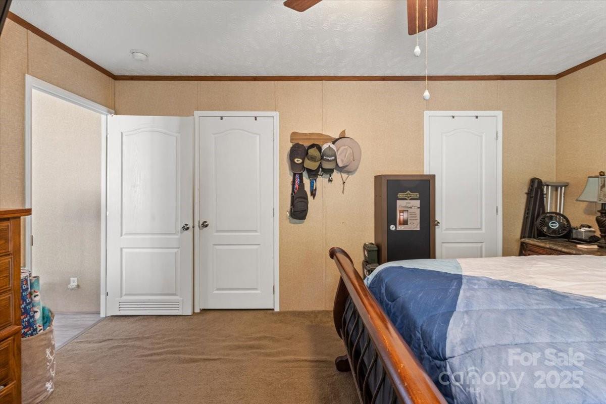 132 Bailey Mountain Road Mars Hill, NC 28754 - Photo 29 of 33 a bedroom with a bed and a refrigerator