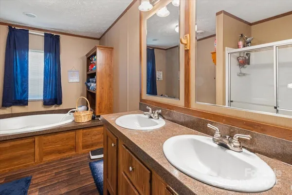 a bathroom with a double vanity sink and a mirror