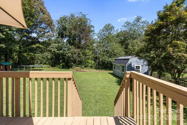 a balcony with wooden floor and fence