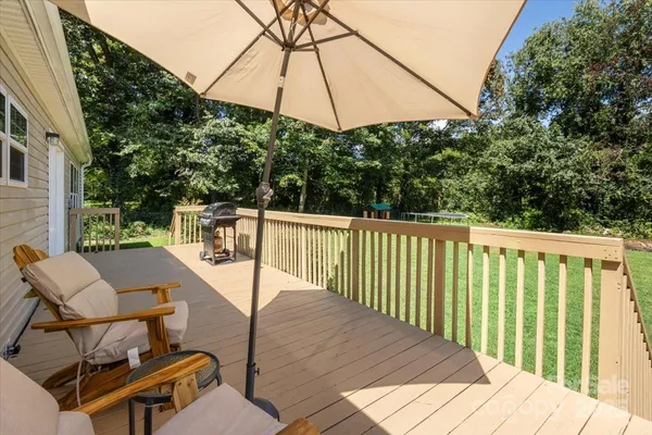 a view of balcony with wooden floor and outdoor seating