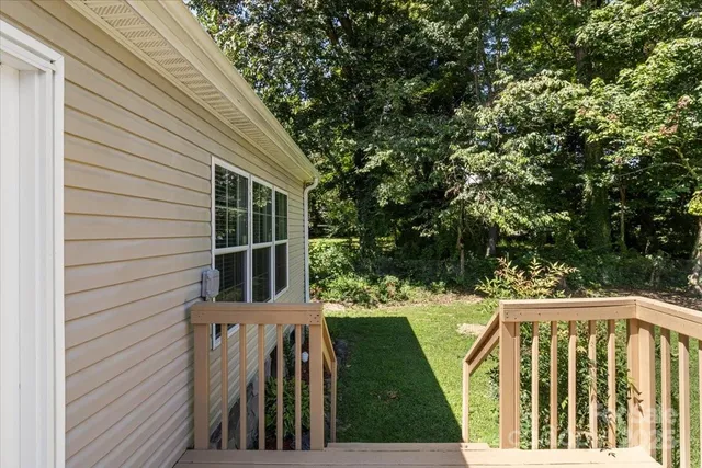 a view of balcony with wooden floor and fence
