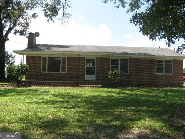 637 Denton Still Road Denton, GA 31532 - Photo 1 of 1 a backyard of a house with yard table and chairs