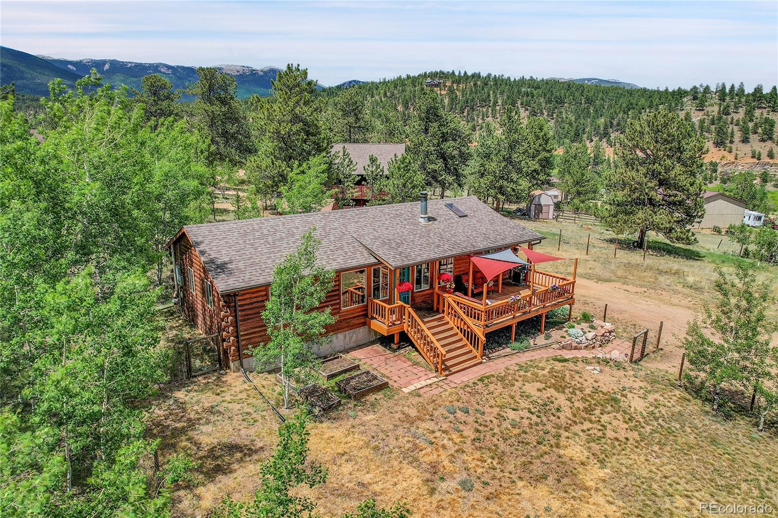 174 Saddlestring Road Bailey, CO 80421 - Photo 1 of 15 an aerial view of a house with porch and outdoor seating