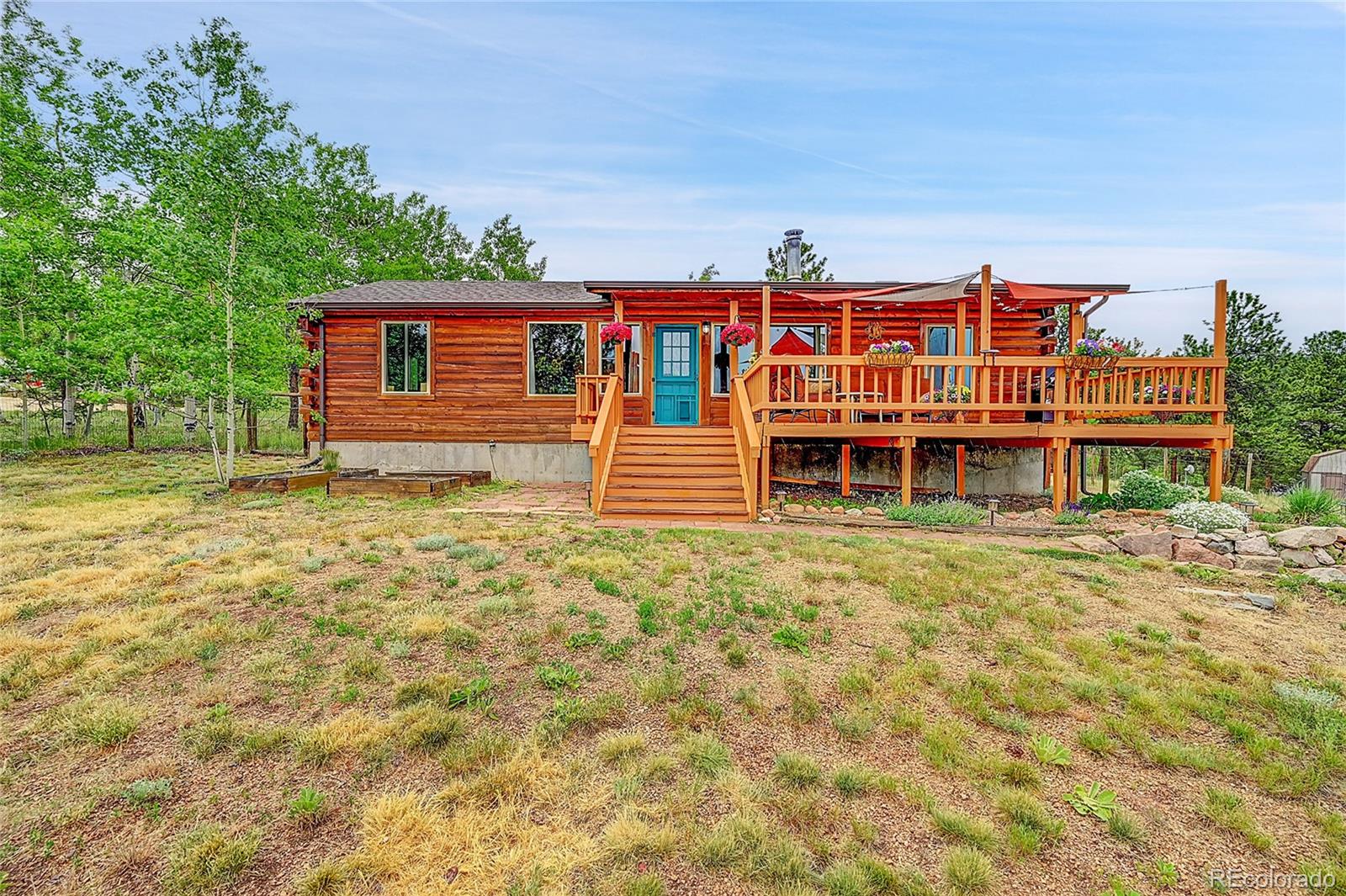 174 Saddlestring Road Bailey, CO 80421 - Photo 13 of 15 a front view of a house with a yard