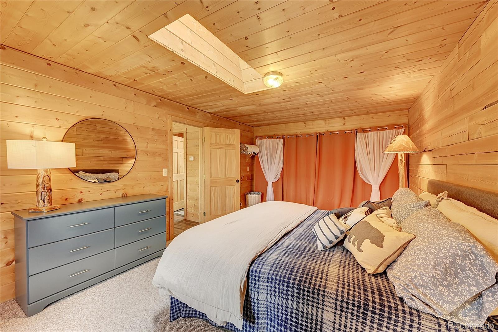174 Saddlestring Road Bailey, CO 80421 - Photo 8 of 15 a bedroom with a bed and a dresser