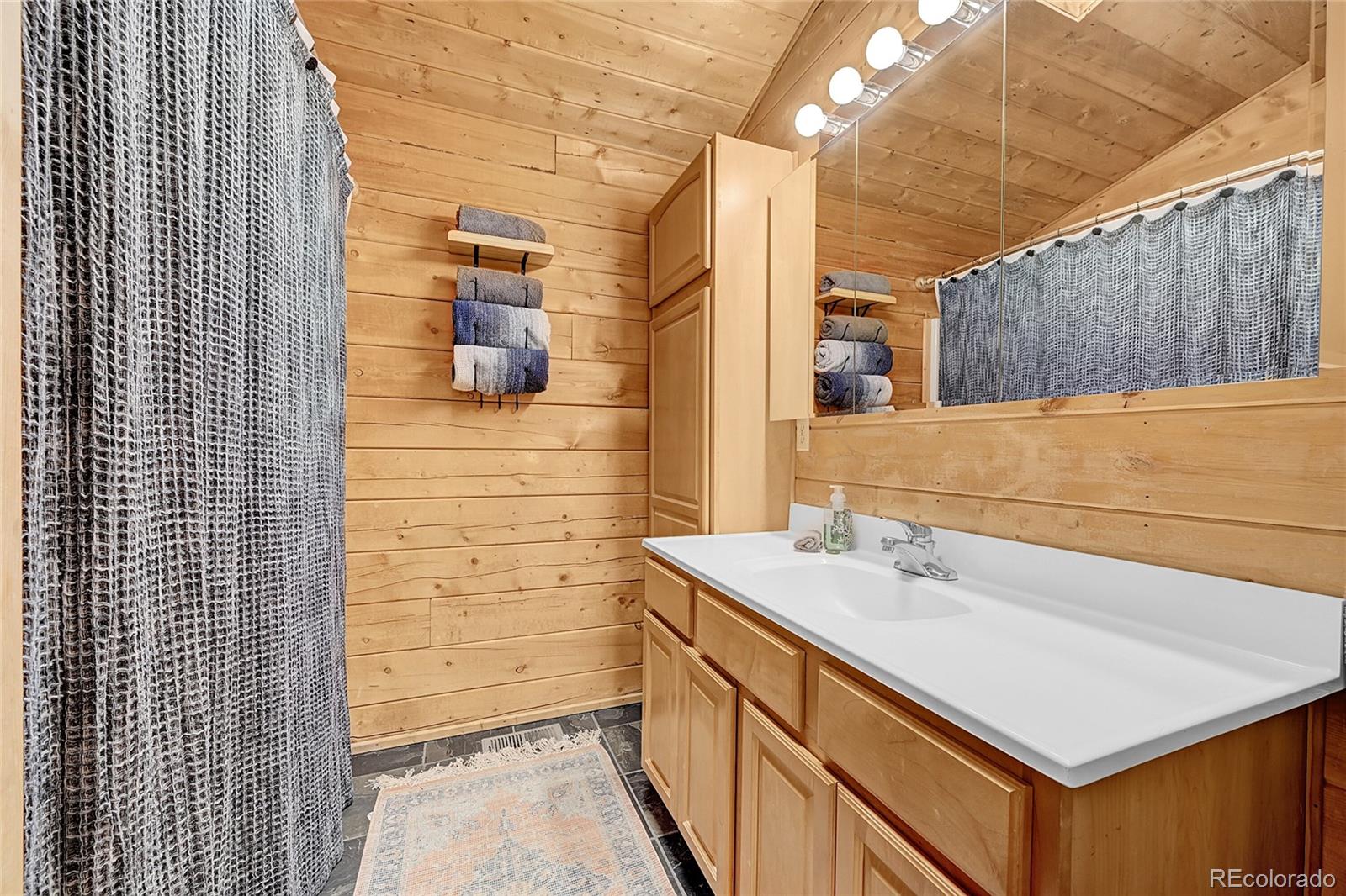 174 Saddlestring Road Bailey, CO 80421 - Photo 10 of 15 a bathroom with a sink and a shower