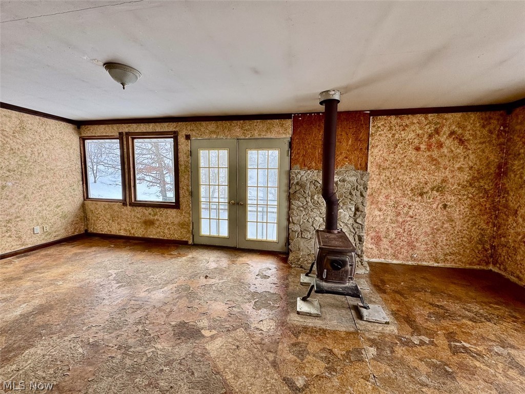 31705 Norris Road Tippecanoe, OH 44699 - Photo 31 of 49 Unfurnished living room featuring french doors and a wood stove