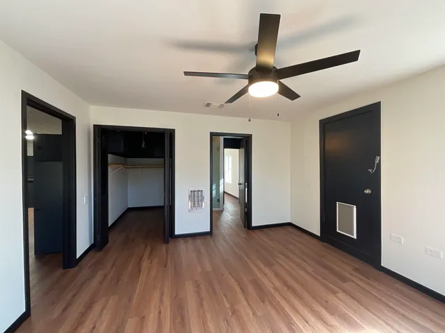a view of empty room with wooden floor