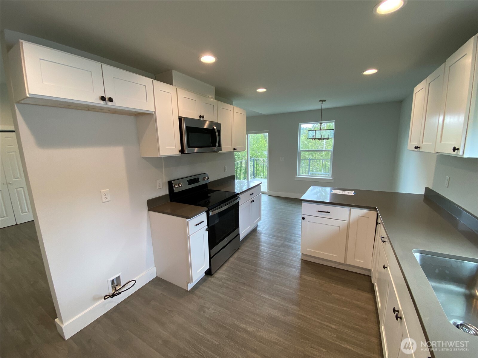 118 Timberline Drive Castle Rock, WA 98611 - Photo 16 of 23 a kitchen with granite countertop a sink a counter top space stainless steel appliances and cabinets