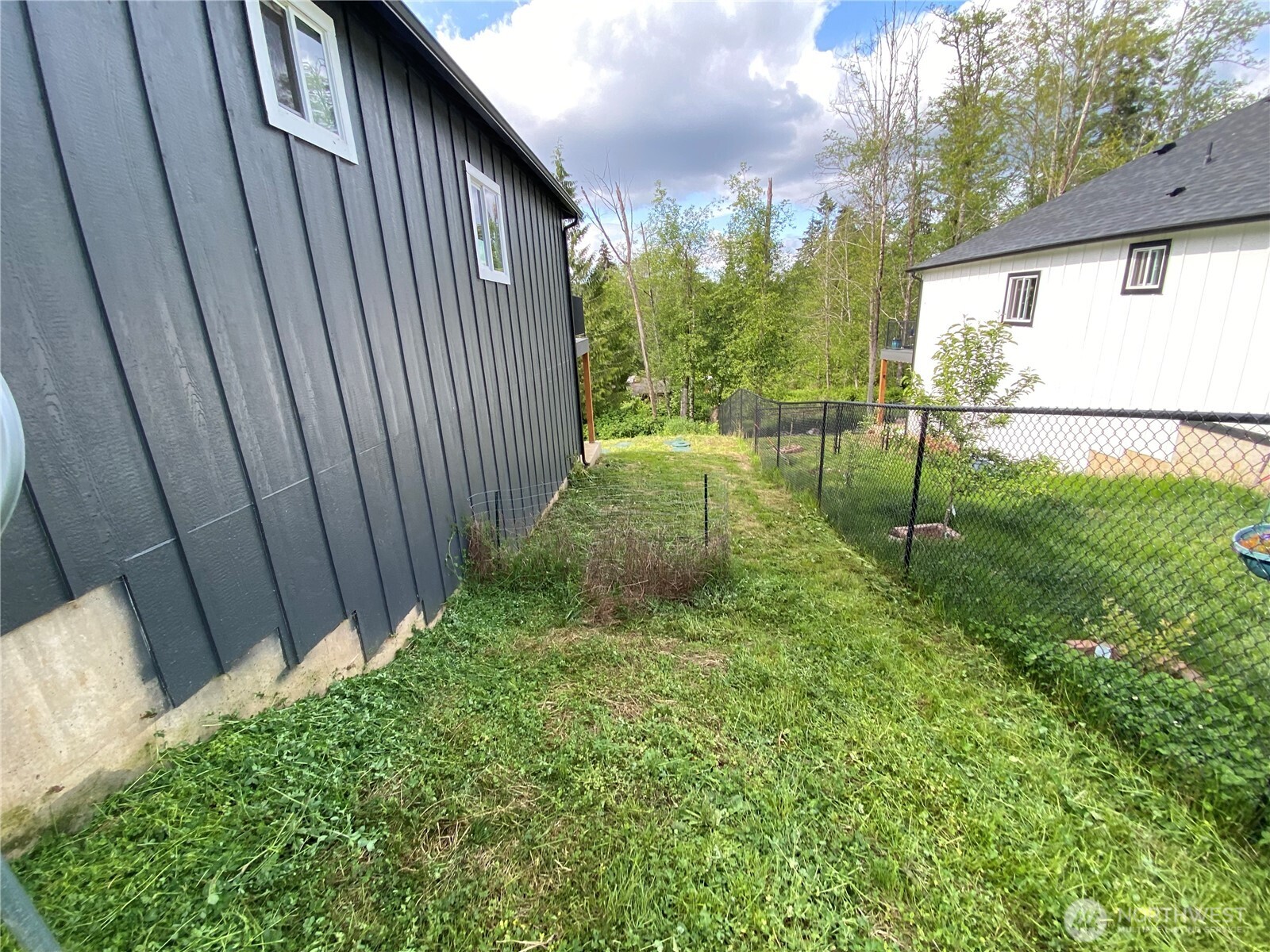 118 Timberline Drive Castle Rock, WA 98611 - Photo 5 of 23 a view of backyard with potted plants and large tree