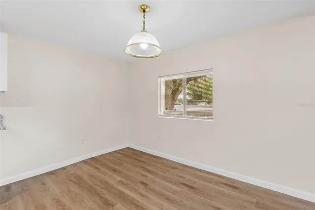 a view of room with window and wooden floor