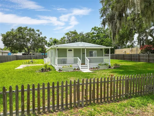 a front view of a house with a yard table and chairs