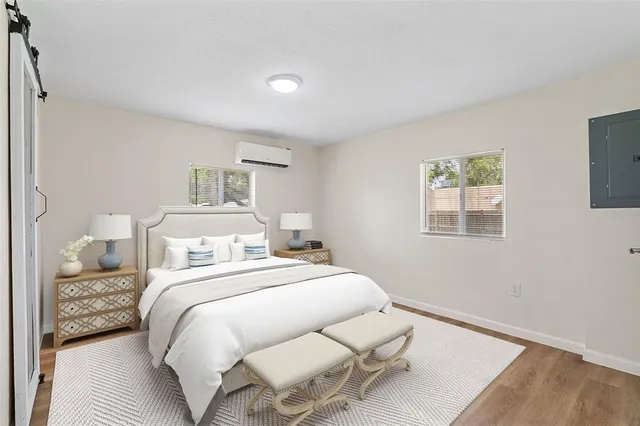 a bedroom with a bed and wooden floor