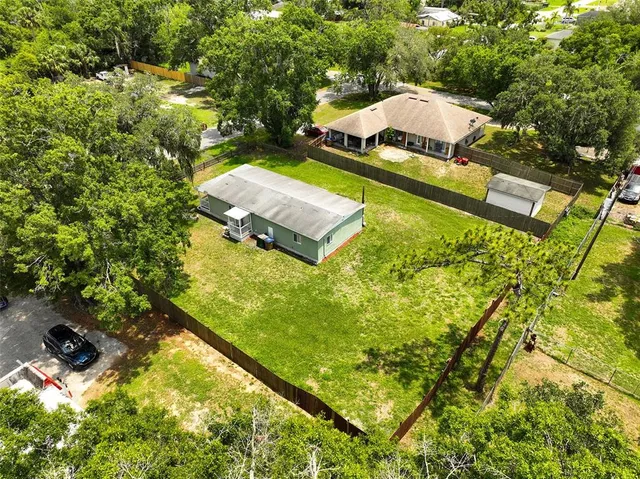 a view of a house with pool yard and outdoor seating
