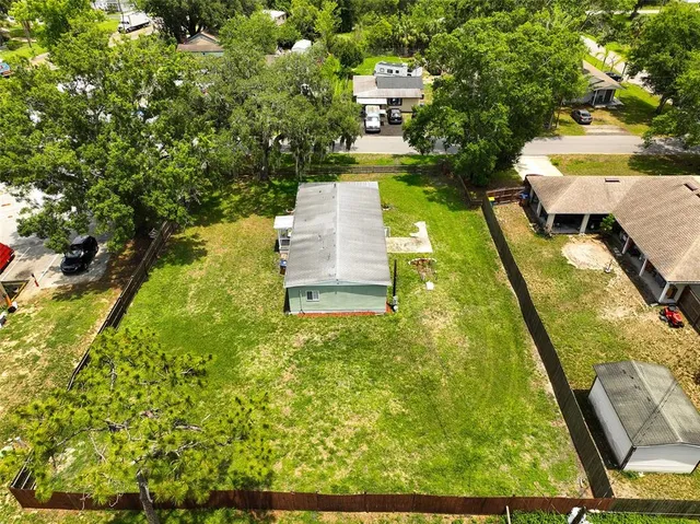a view of a yard with chairs