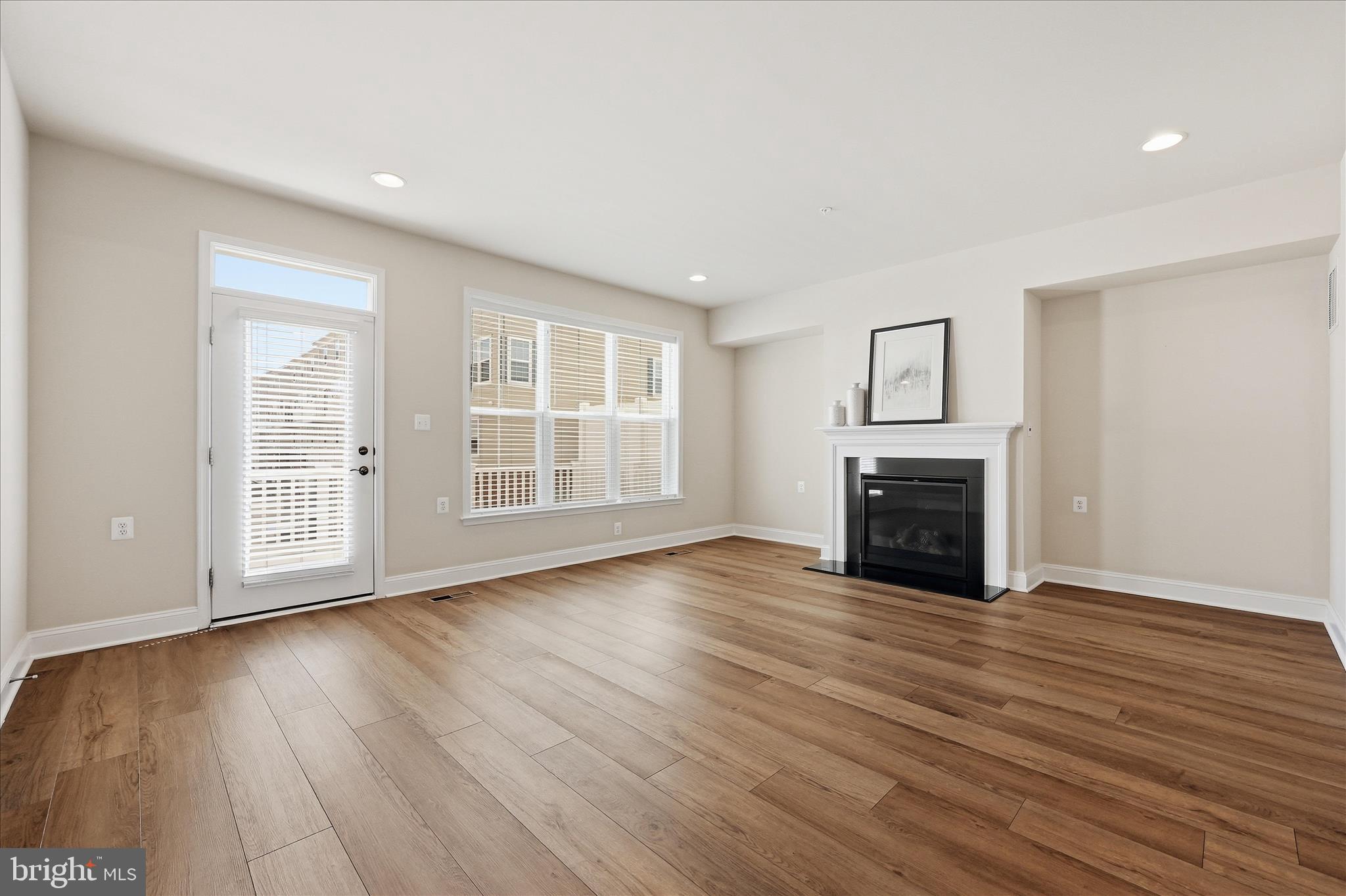 1090 Holden Road Frederick, MD 21701 - Photo 5 of 60 a view of an empty room with wooden floor and a window