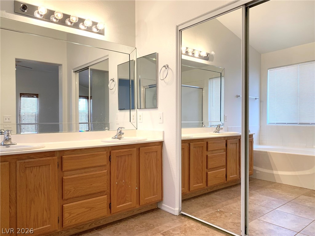 3821 Bombastic Court Las Vegas, NV 89147 - Photo 18 of 36 This bright bathroom features a spacious vanity and ample natural light.
