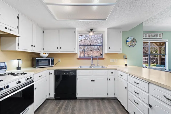 a kitchen with white cabinets and a sink