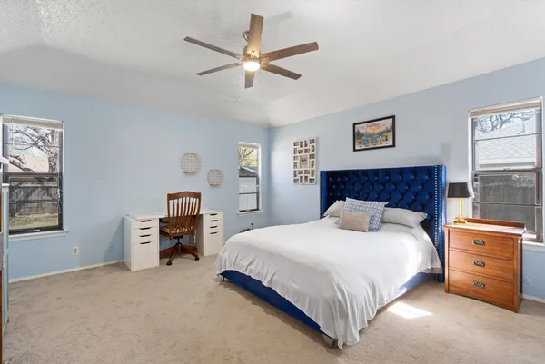 a bedroom with a bed dresser and a window