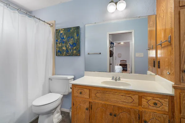 a bathroom with a sink toilet and mirror