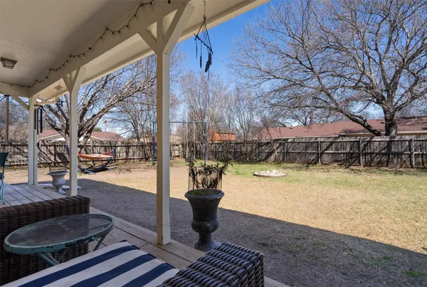 a swimming pool with outdoor seating and yard
