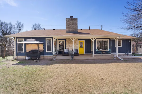 a view of a house with backyard porch and sitting area