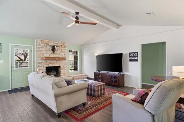 a living room with furniture a rug and a table