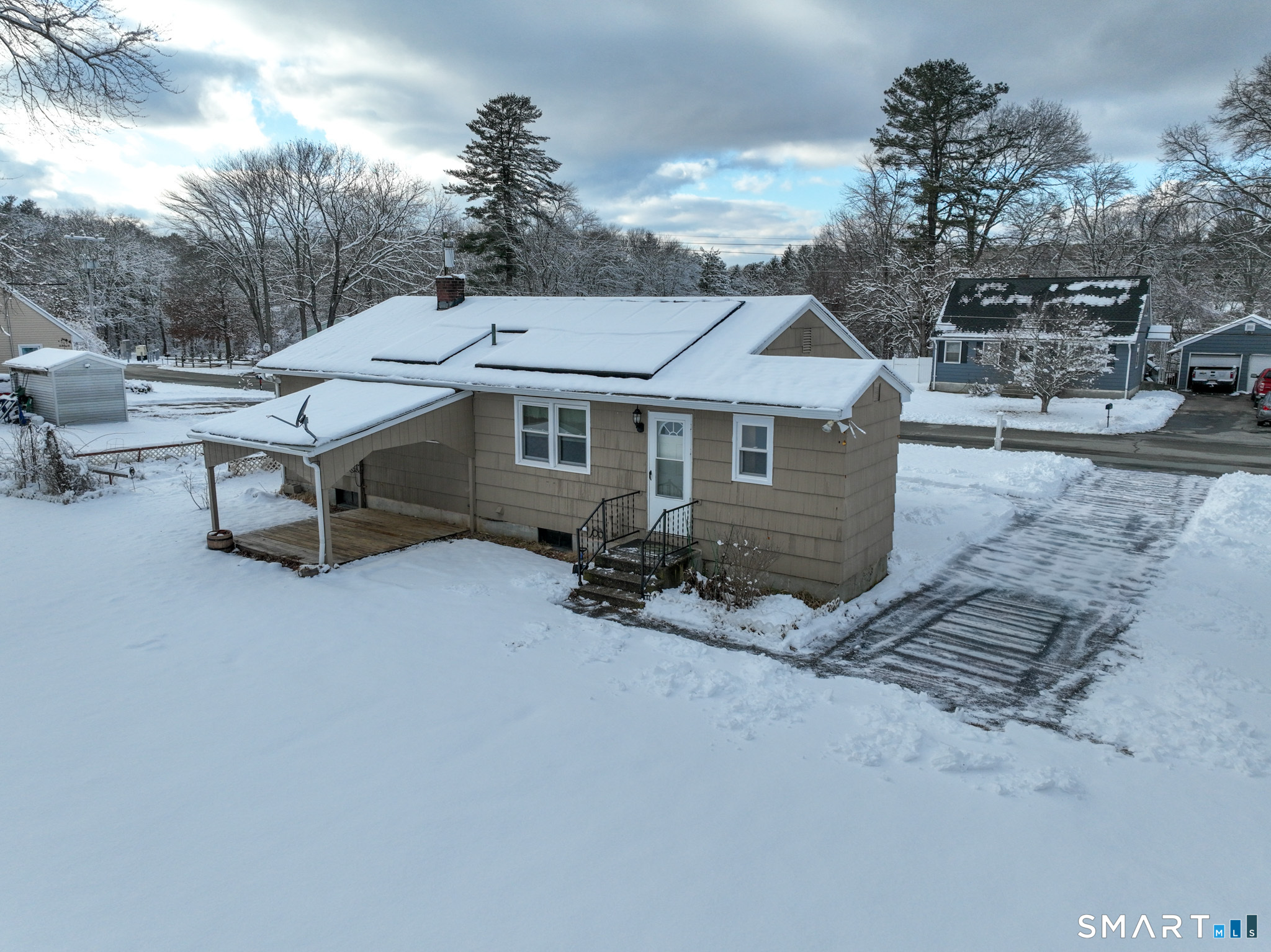 19 Plaza Street Brooklyn, CT 06234 - Photo 28 of 33 an aerial view of a house with table and chairs under an umbrella