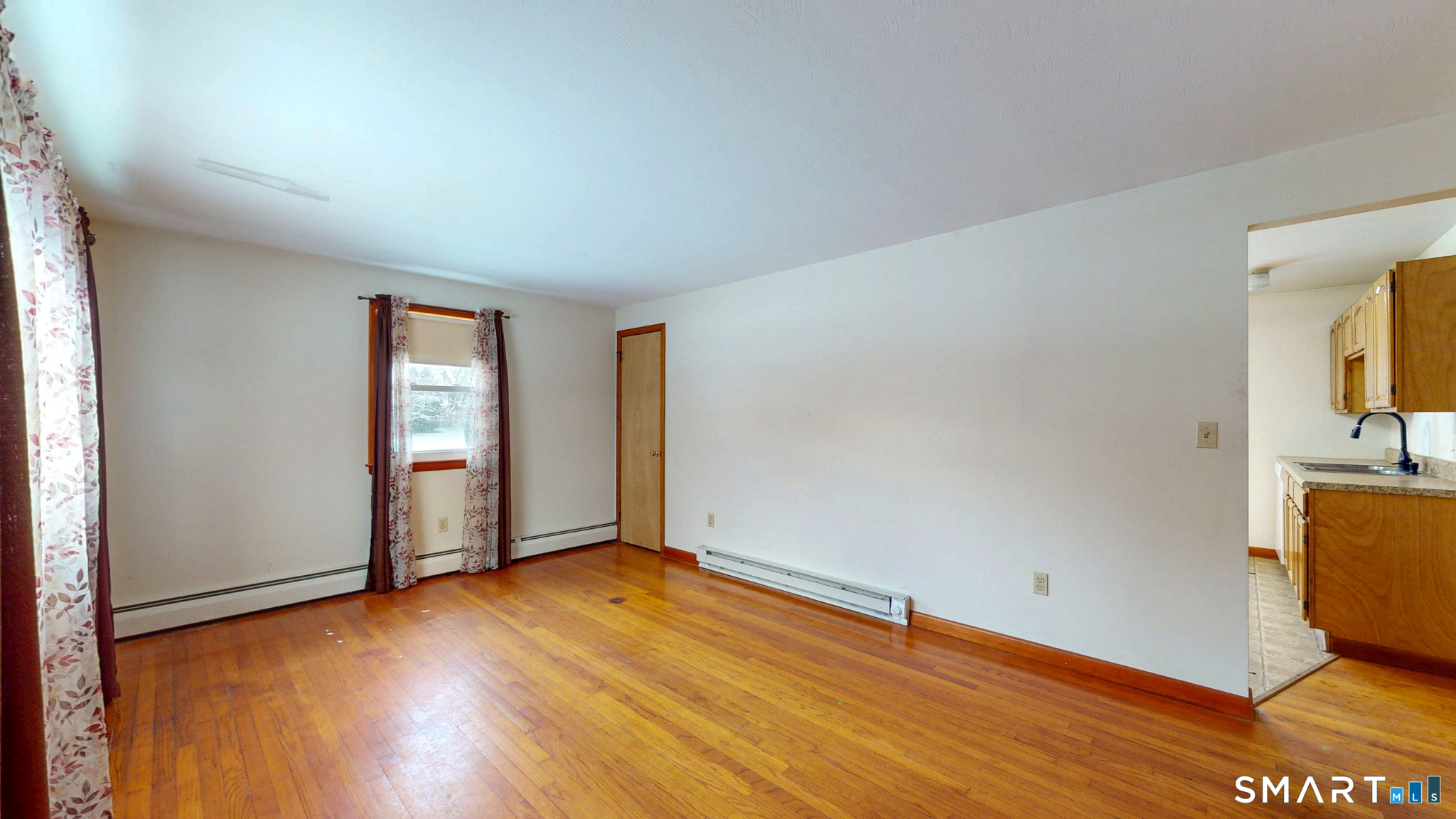 19 Plaza Street Brooklyn, CT 06234 - Photo 6 of 33 an empty room with wooden floor and windows