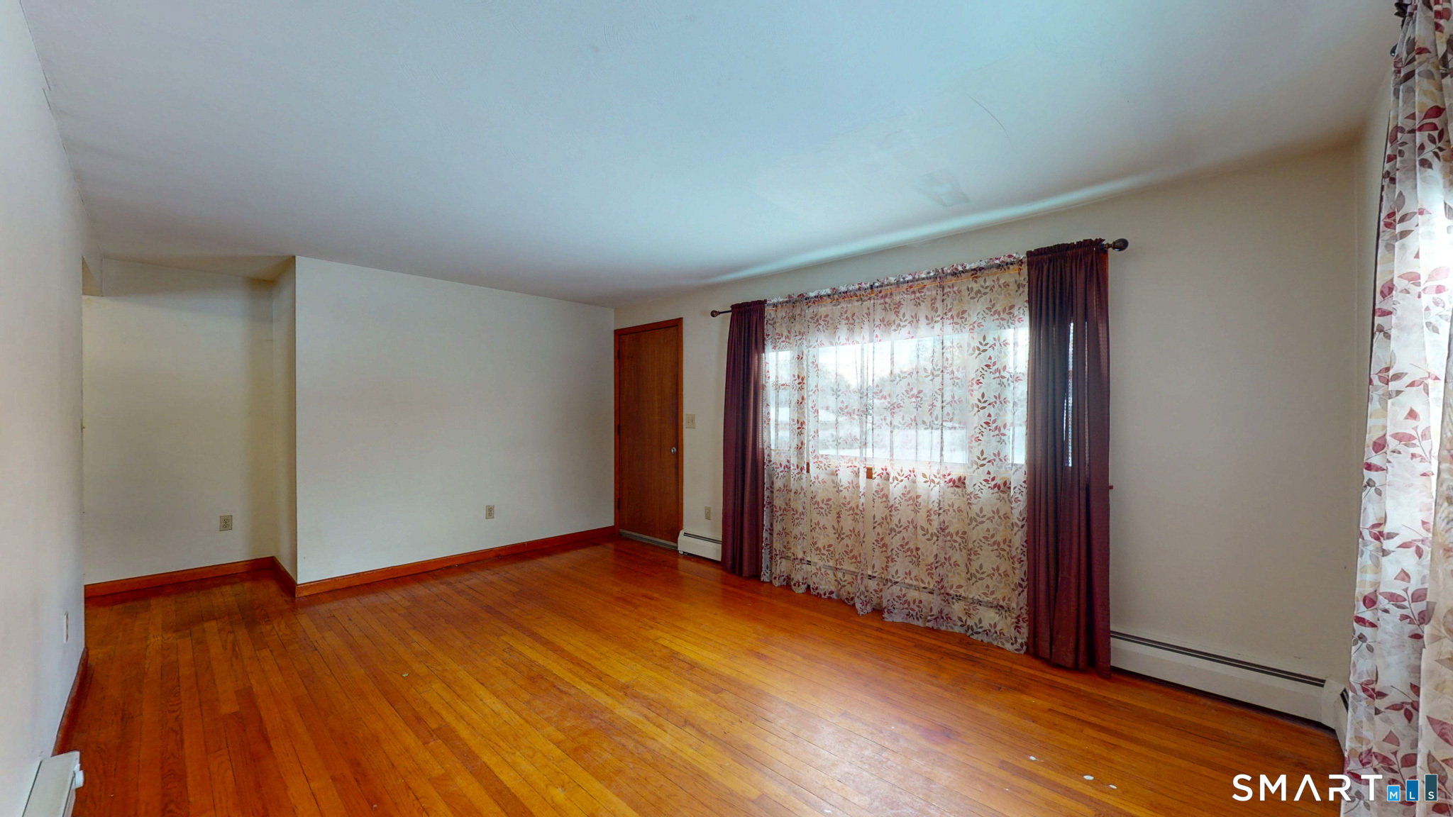 19 Plaza Street Brooklyn, CT 06234 - Photo 8 of 33 an empty room with wooden floor and windows