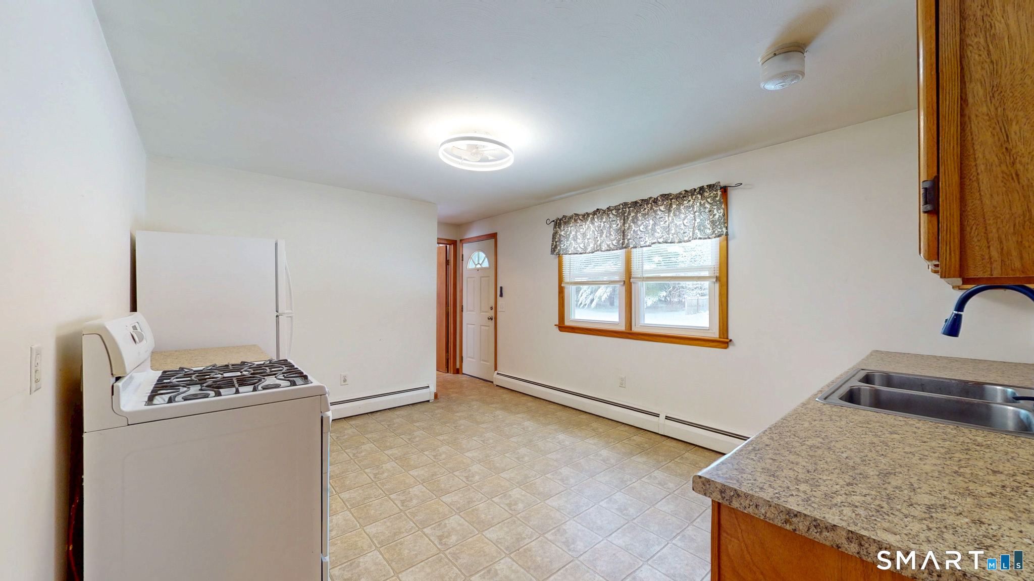 19 Plaza Street Brooklyn, CT 06234 - Photo 9 of 33 a kitchen that has a sink a stove and a window