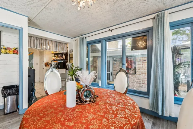 a bedroom with furniture and large windows