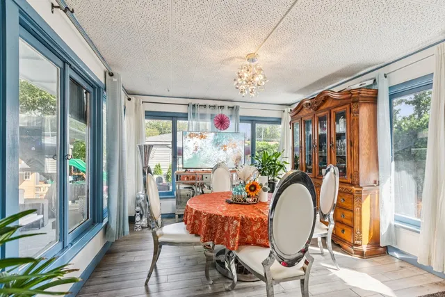 a view of a dining room with furniture wooden floor and a chandelier