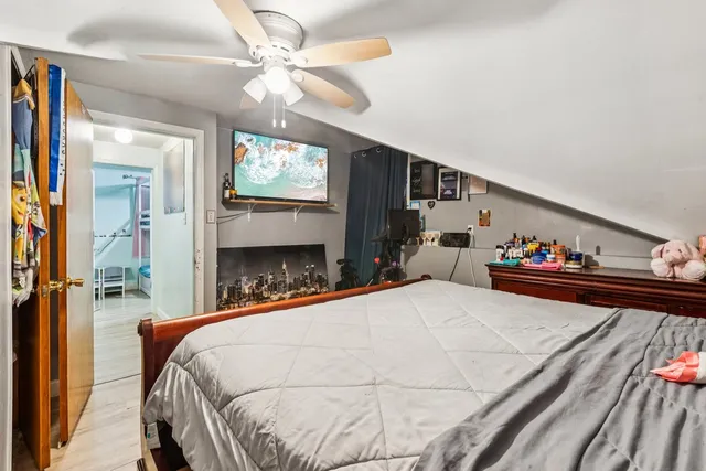 a bed sitting in a bedroom and chandelier