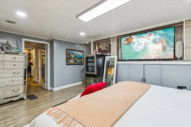 a bedroom with a bed and a flat screen television