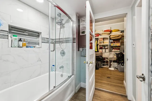 a bathroom with a bathtub and a shower