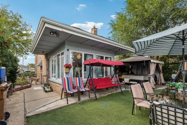 a view of a patio with table and chairs and potted plants