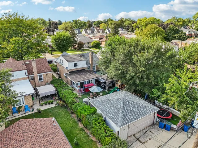 an aerial view of a house with garden space and street view