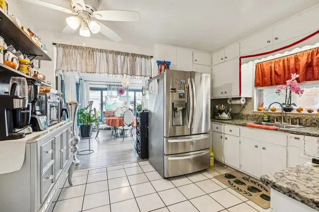 a kitchen with stainless steel appliances granite countertop a refrigerator and a sink